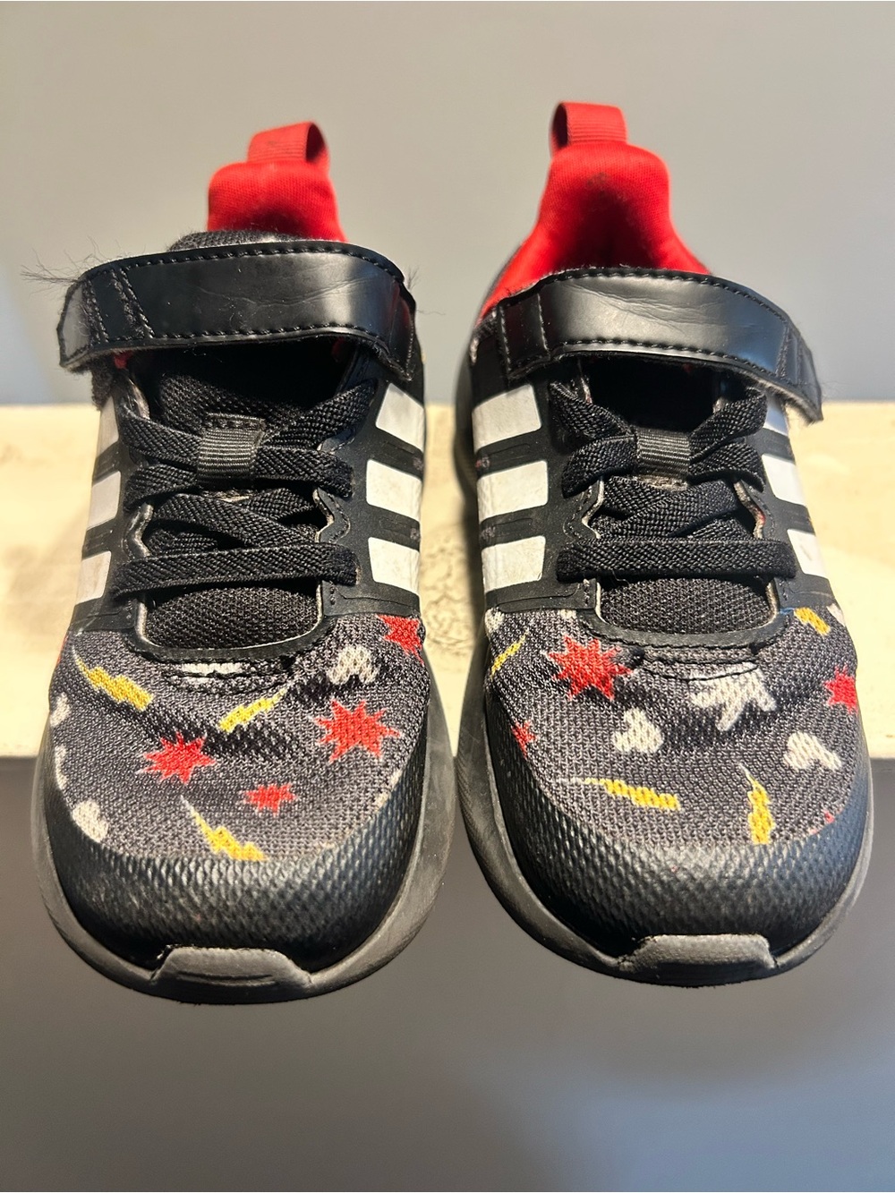 adidas Black Kids Sneakers with Red and Yellow Star Accents